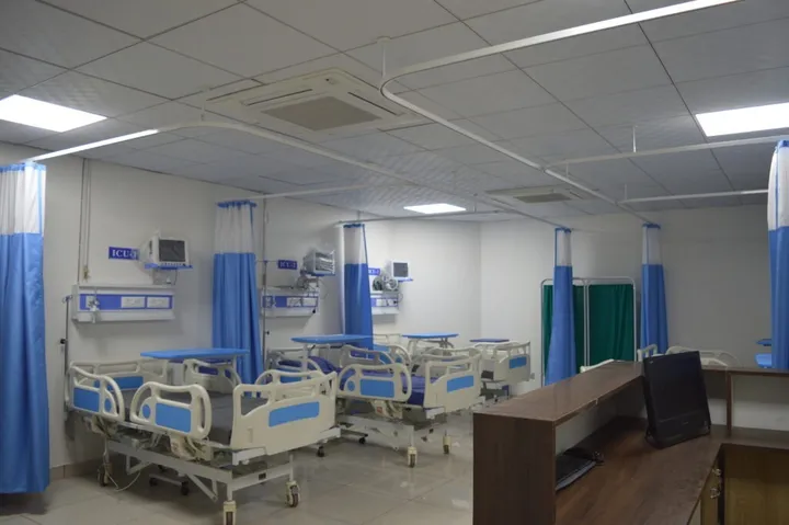 The intensive care unit, with numbered bays, bedside monitors and curtain screening between beds